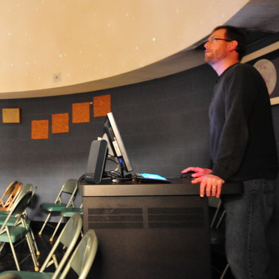 instructor lecturing inside observatory